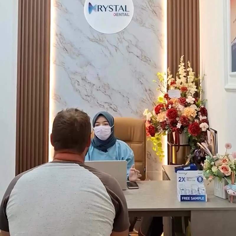 An international patient in a consultation with a dentist at Krystal Dental